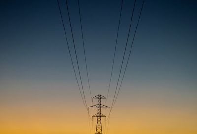 Low angle view of electricity pylon against sky