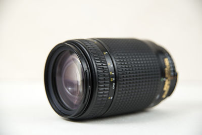 Close-up of camera on table against white background