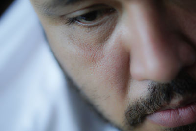 Close-up of serious man looking down