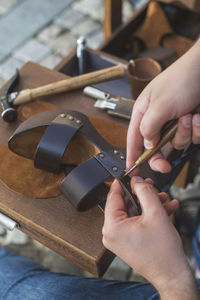Close-up of shoemaker making sandal at workshop