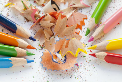 High angle view of multi colored pencils and shavings on table