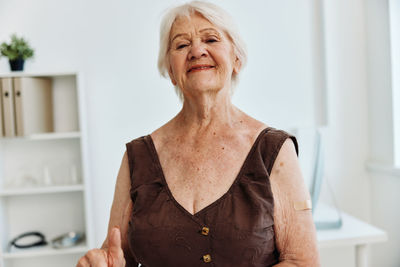 Portrait of woman standing at home