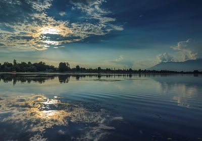 Scenic view of lake against sky at sunset