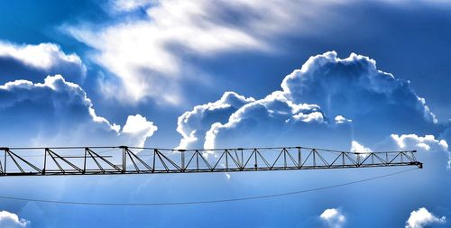 Low angle view of silhouette bridge against sky