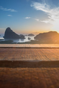 Surface level of beach against sky during sunset