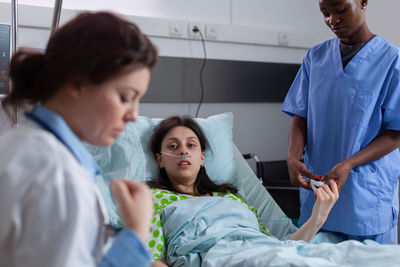 Female patient lying on bed at hospital