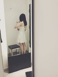 Young man looking through window