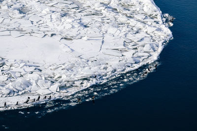 High angle view of snow on sea