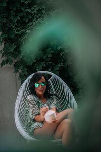 Young woman drinking water from coffee