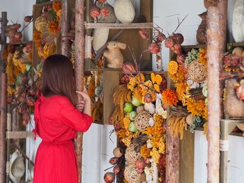 Woman looking at decoration in market stall