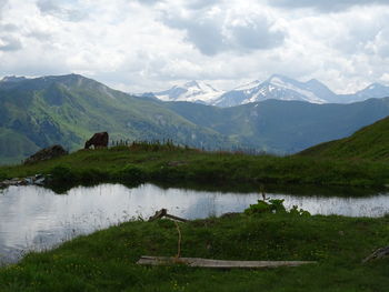 Scenic view of lake and mountains against sky