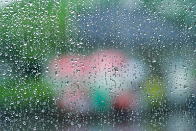 Full frame shot of wet glass window during rainy season