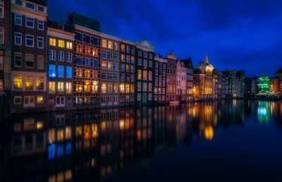 Reflection of illuminated buildings in city at night