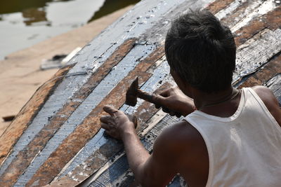 Rear view of man holding umbrella