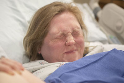 Midsection of woman lying on bed