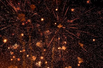 Low angle view of firework display at night