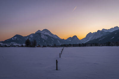 Scenic view of snowcapped mountains against sky during sunset