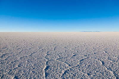 Scenic view of desert against clear blue sky