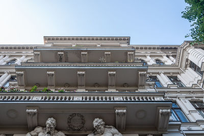 Low angle view of building with balkonys against clear sky