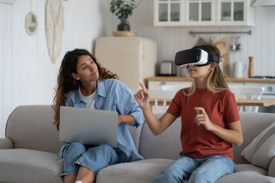 Mother limiting child use of vr technologies, teen girl spending too much time in virtual world