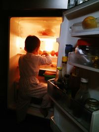 Rear view of boy at home