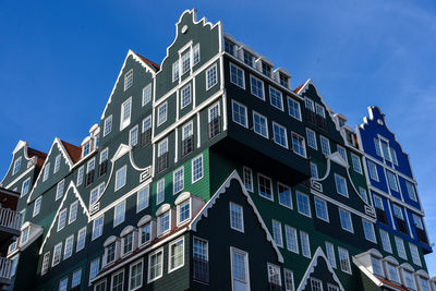 Low angle view of modern building against clear blue sky