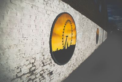 Close-up of road sign against wall