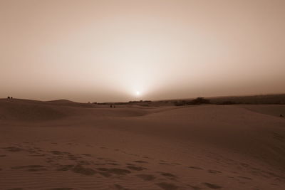 Scenic view of desert against sky during sunset