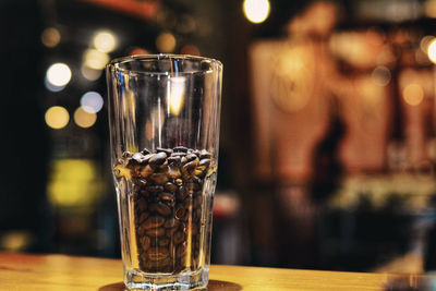 Close-up of roasted coffee beans in drinking glass