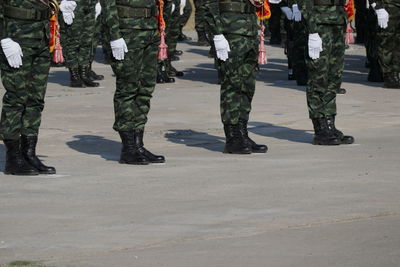 Low section of soldiers walking on street