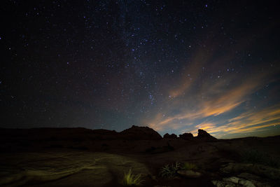 Scenic view of landscape against sky at night