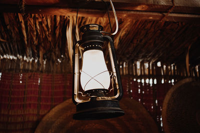 Close-up of illuminated lamp hanging on roof