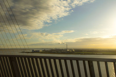 Suspension bridge against sky during sunset