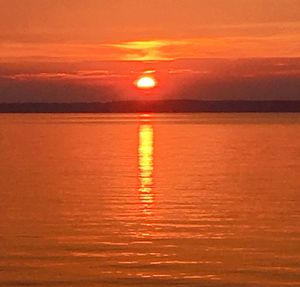 Scenic view of sea against romantic sky at sunset