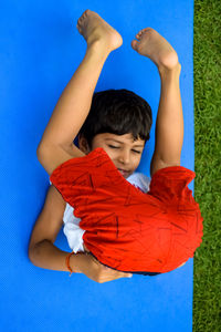 Asian smart kid doing yoga pose in the society park outdoor, children's yoga pose. the little boy