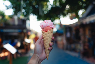 Cropped hand holding ice cream cone