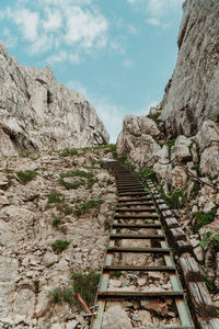 Low angle view of steps leading towards mountain against sky
