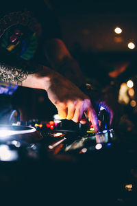 Hands of illuminated lighting equipment at night