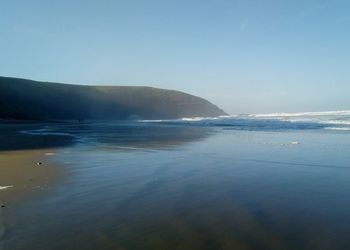 Scenic view of sea against clear blue sky