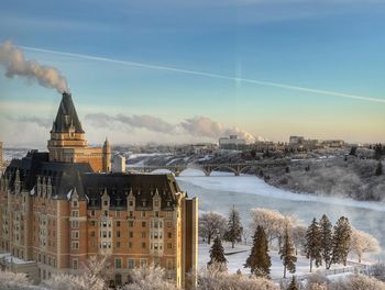 Buildings in city against sky during sunset