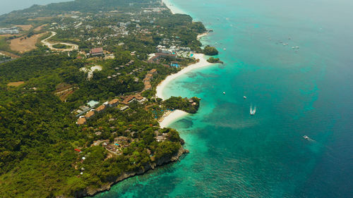 Shore of the tropical island of boracay with sandy beaches and hotels from above. 
