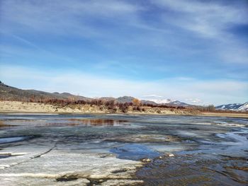 Scenic view of lake against sky during winter