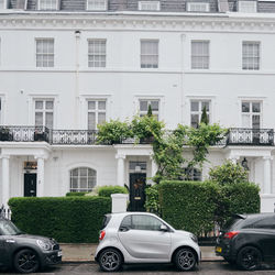 Cars on street against buildings