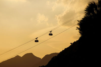 Low angle view of silhouette mountains against sky during sunset