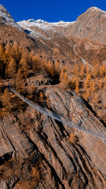 Aerial view of man walking on footbridge against landscape