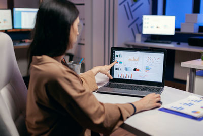 Side view of businesswoman working in office