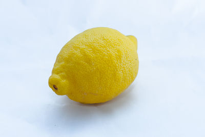 Close-up of lemon slice against white background
