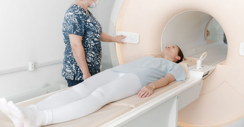 Doctor or nurse and patient with tomography ct or mri scan in hospital. radiography department. 