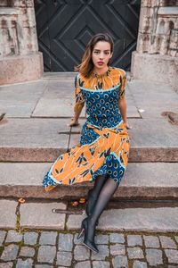 Portrait of beautiful woman sitting outdoors