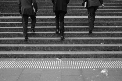 Low section of people walking on stairs